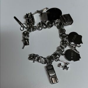 R L Griffith son’s Vintage Sterling Silver Charm Bracelet with 11 Charms. 48 Gms